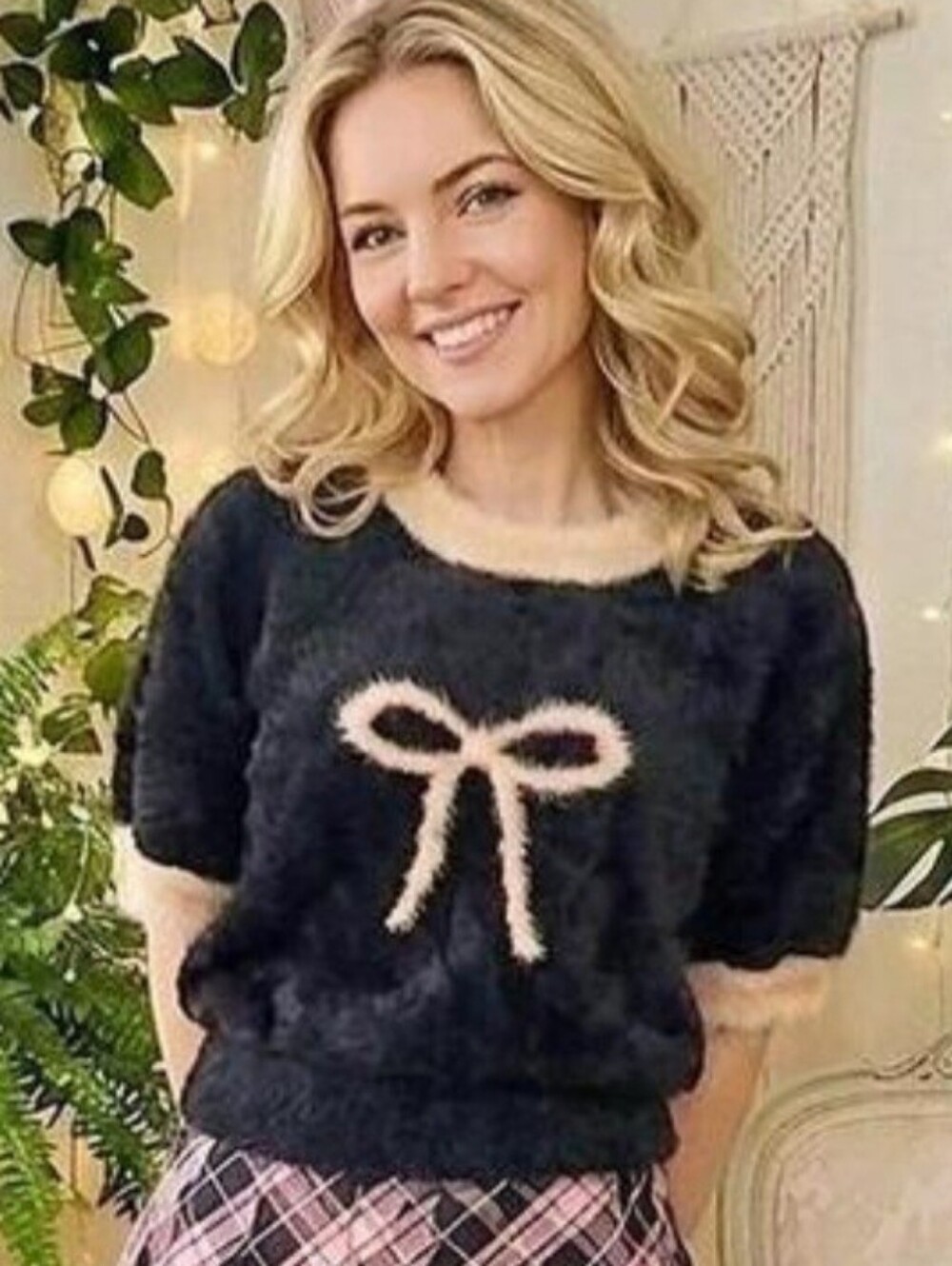 FASHION NOVA Soft black fuzzy short sleeve sweater with a cream bow detail.